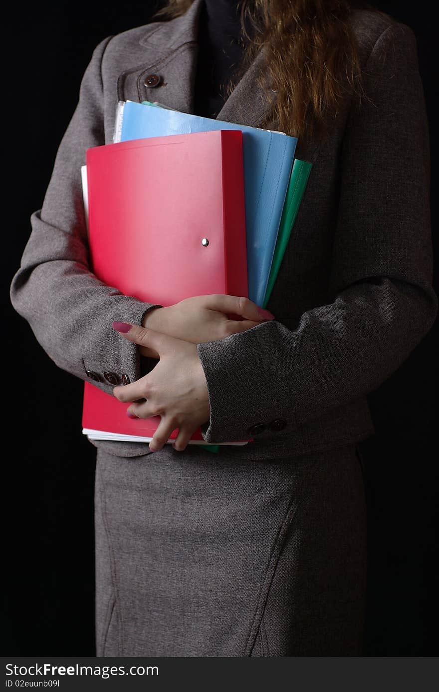 Business woman and folders on black background