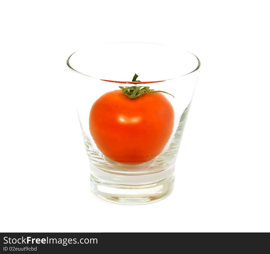 fresh tomato in glass isolated on white