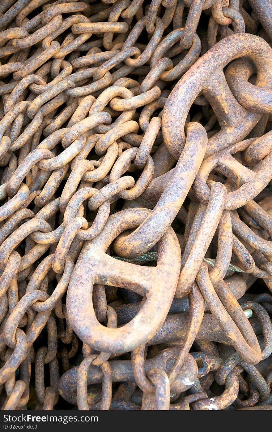 Rusty big chains for industrial use seen in a harbour. Rusty big chains for industrial use seen in a harbour