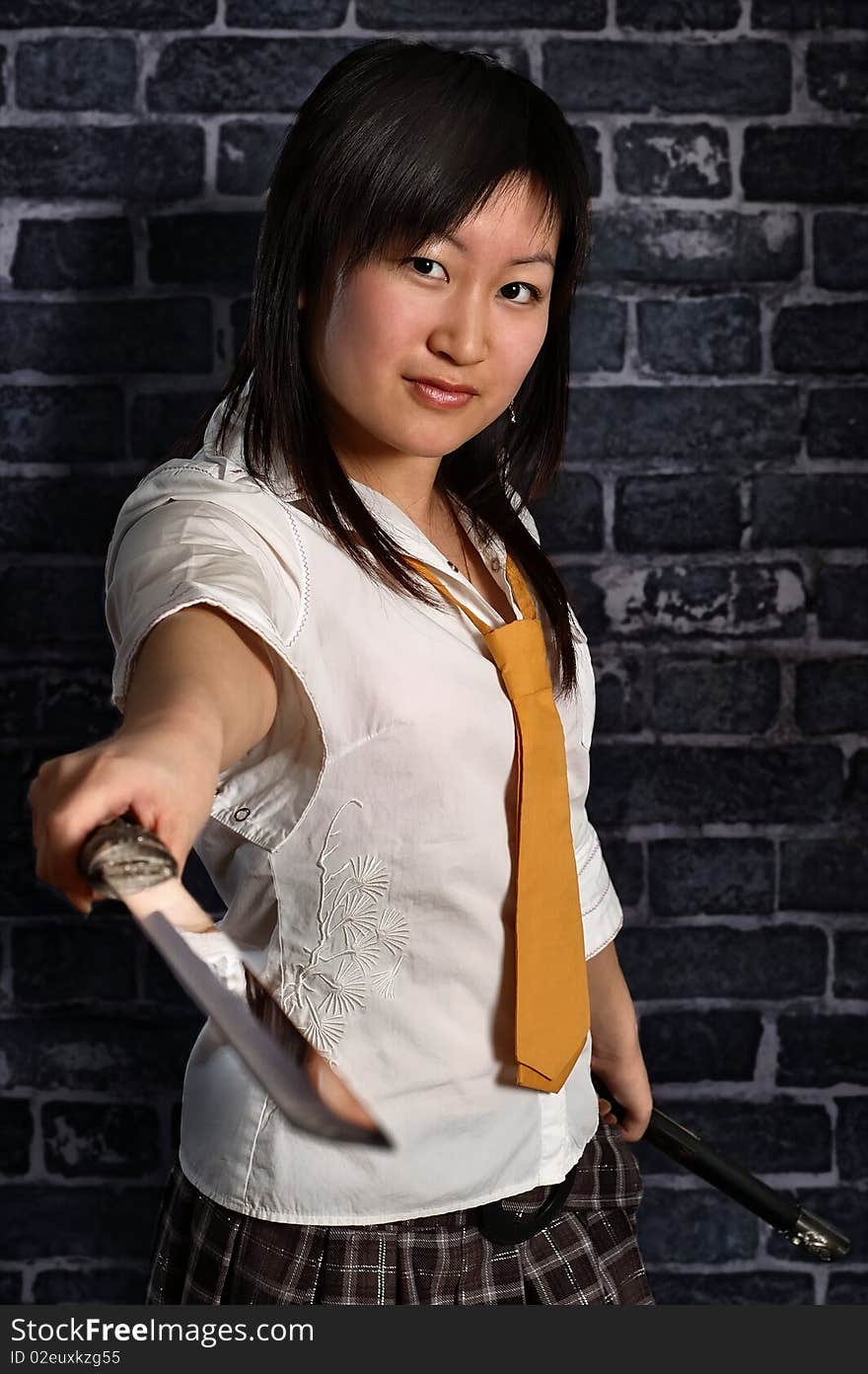 Beautiful japan schoolgirl with katana in her hand. Beautiful japan schoolgirl with katana in her hand