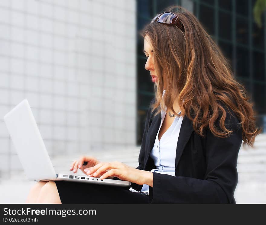 Young beautiful business woman with laptop. Young beautiful business woman with laptop