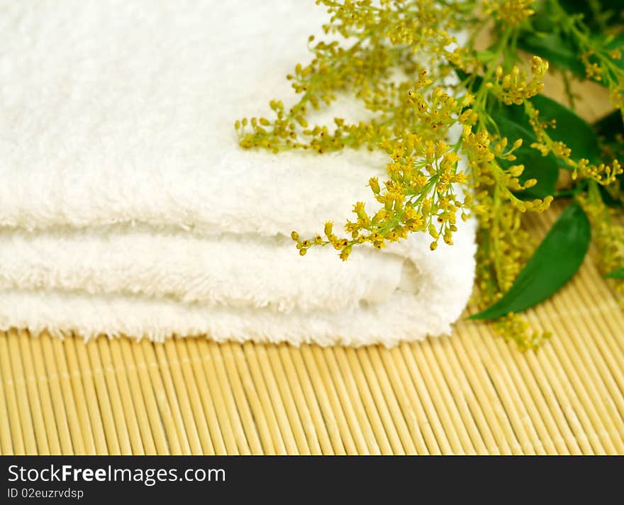 spa composition of towel and flowers