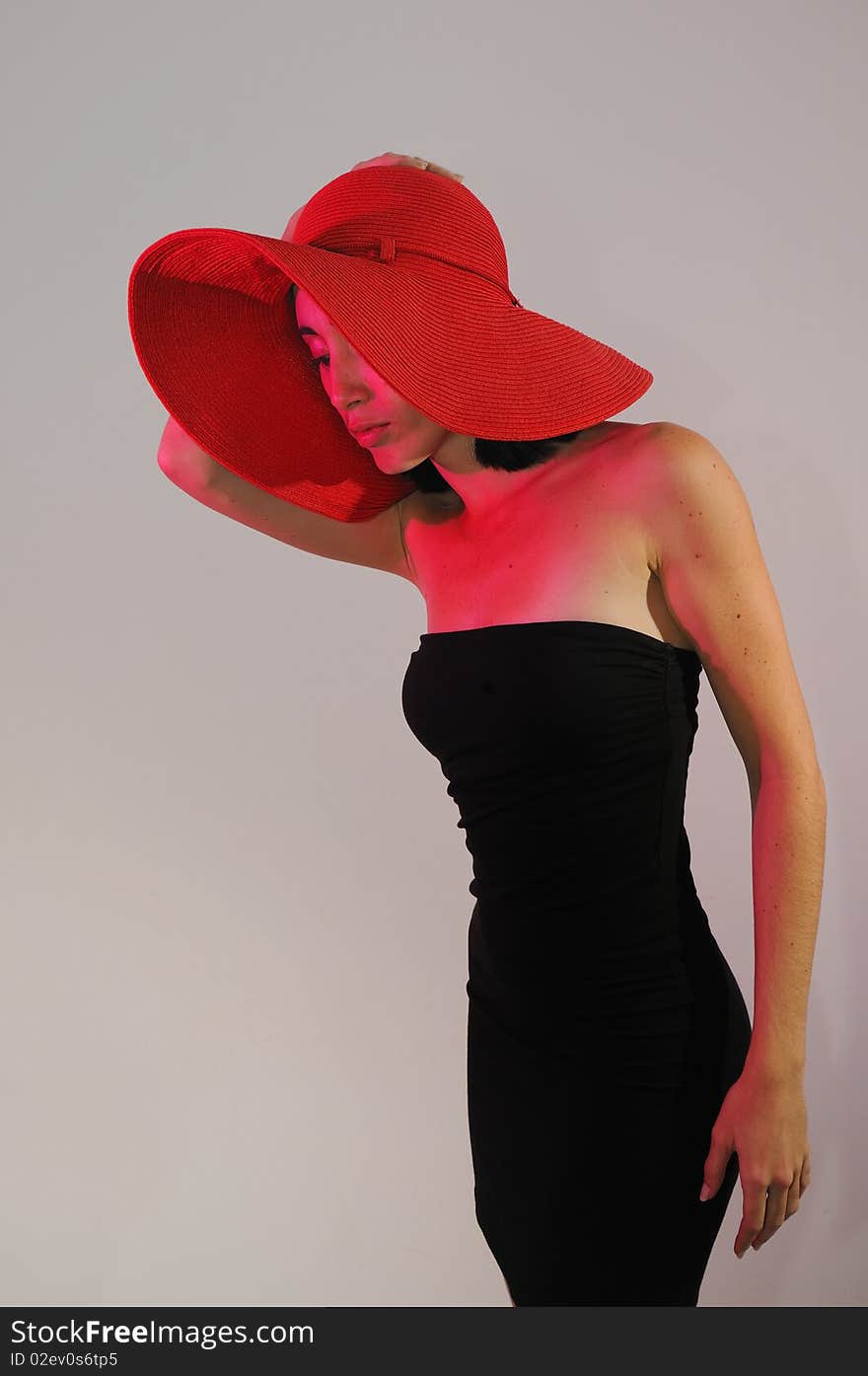 Portrait of young stylish woman on black dress wearing a hat. Portrait of young stylish woman on black dress wearing a hat