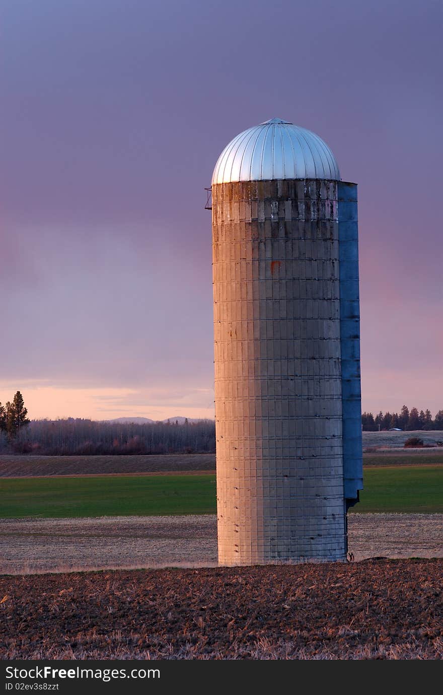 Sunset illuminates a grain silo in the wheat fields of the Palouse, Washington's wheat growing region. Sunset illuminates a grain silo in the wheat fields of the Palouse, Washington's wheat growing region