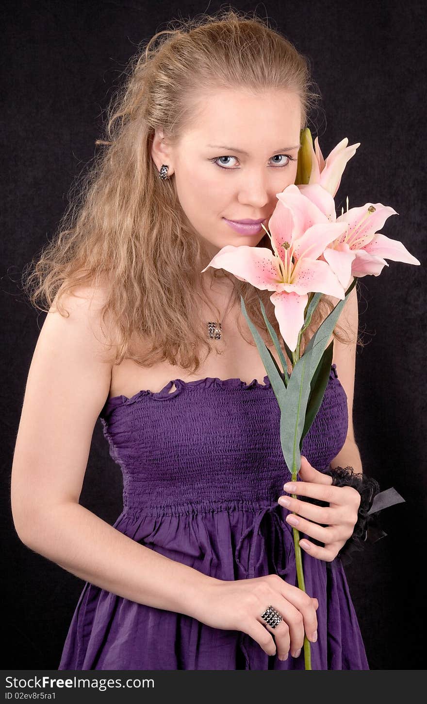 Portrait of a young girl with a lily flower. Portrait of a young girl with a lily flower