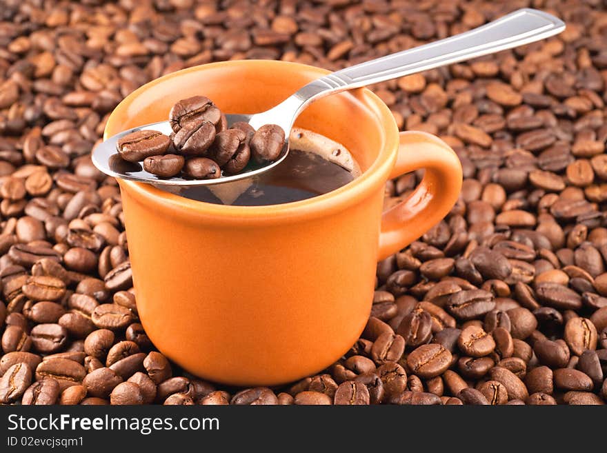 Cup of coffee on a background of coffee grains.