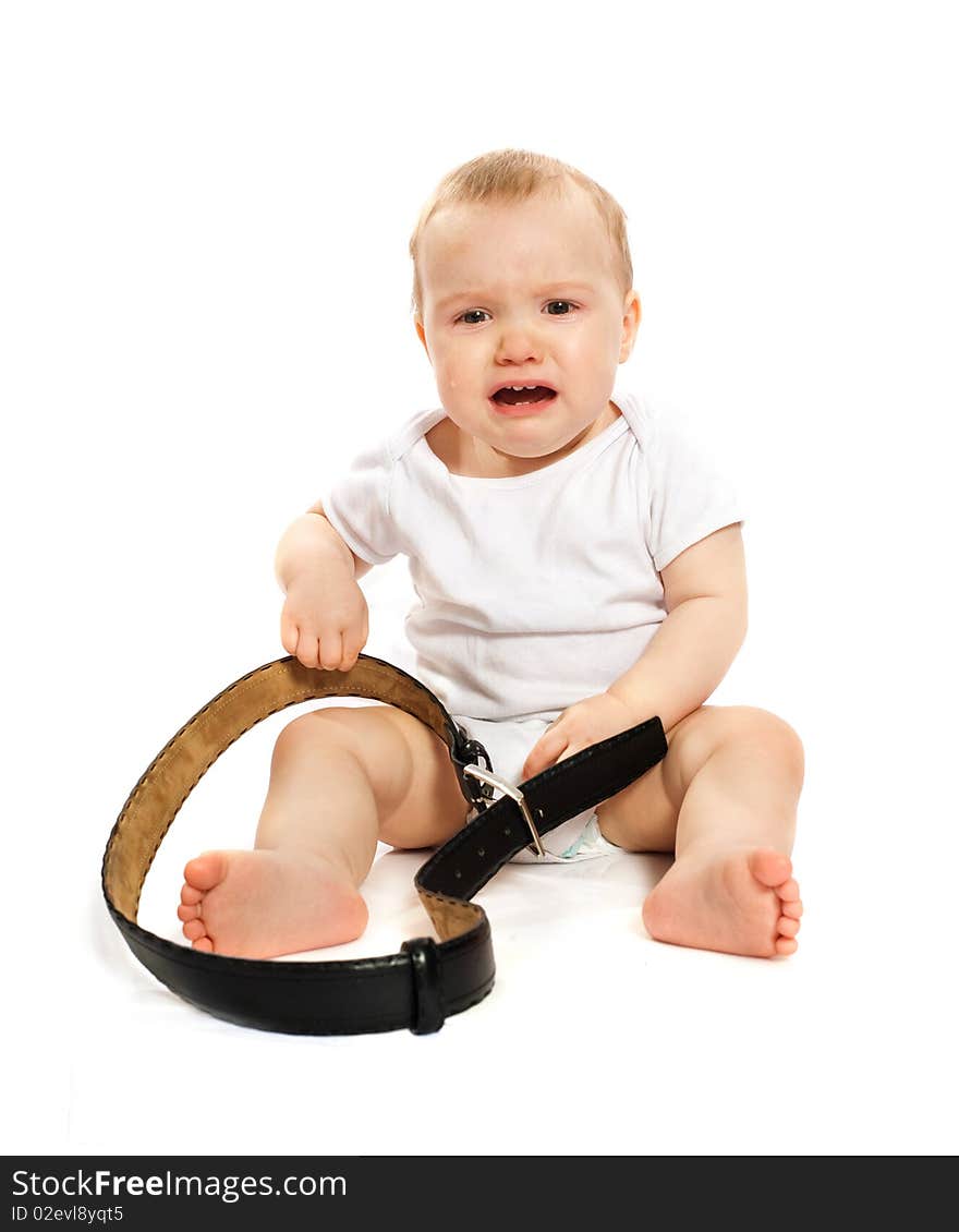 Unhappy 1-year old baby with a belt