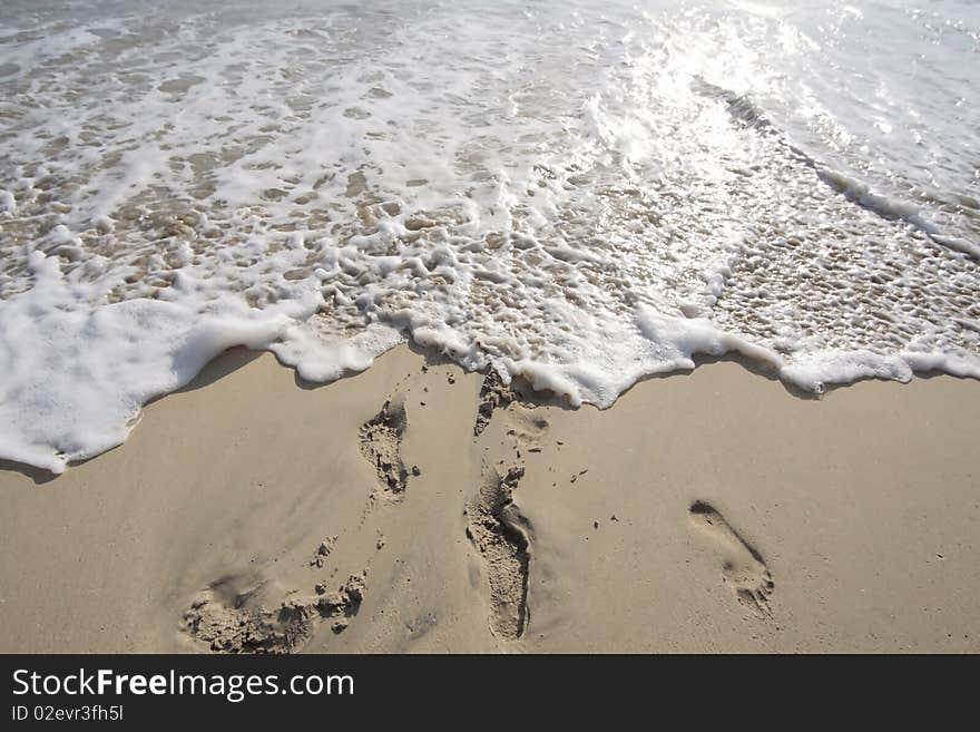 Traces on seacoast washed off by a wave. Traces on seacoast washed off by a wave