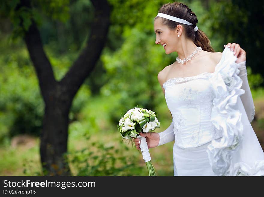 A happy bride near the tree. A happy bride near the tree