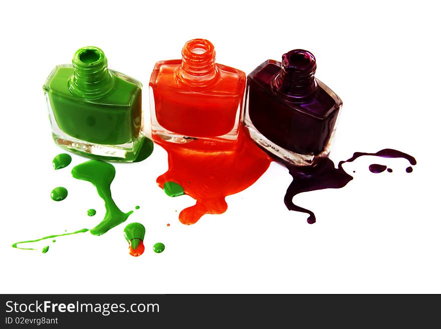 Three vials of a varnish, varnish drop on a white background