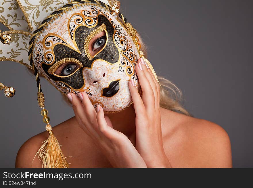 Young woman wearing carnival mask