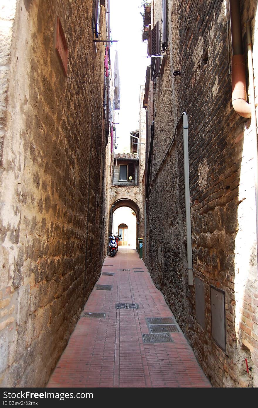 Narrow street in San Giminiano fortress, Tuscany, Italy
