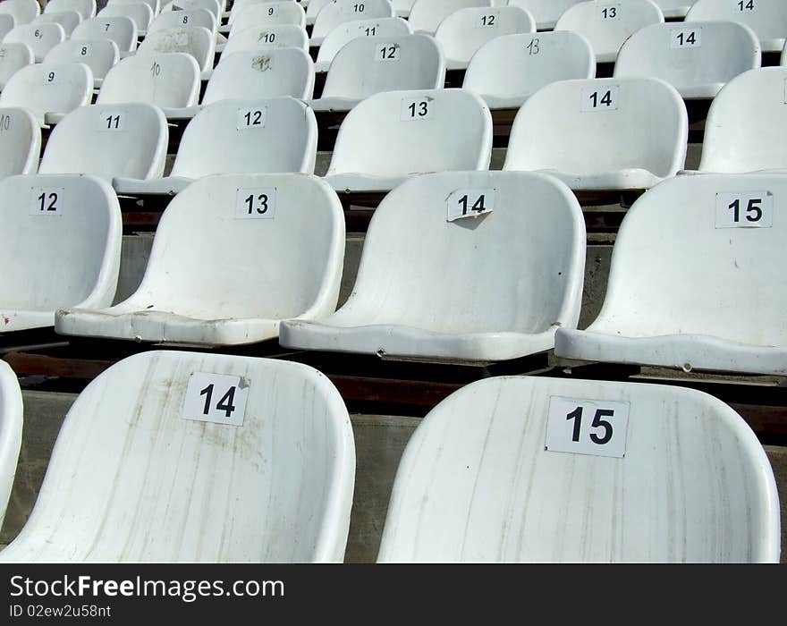 Some dirty chairs on a stadium