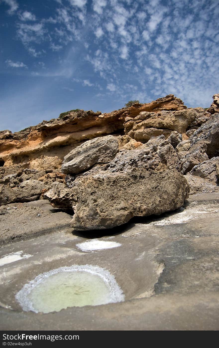 Salty rocks with blue sky above