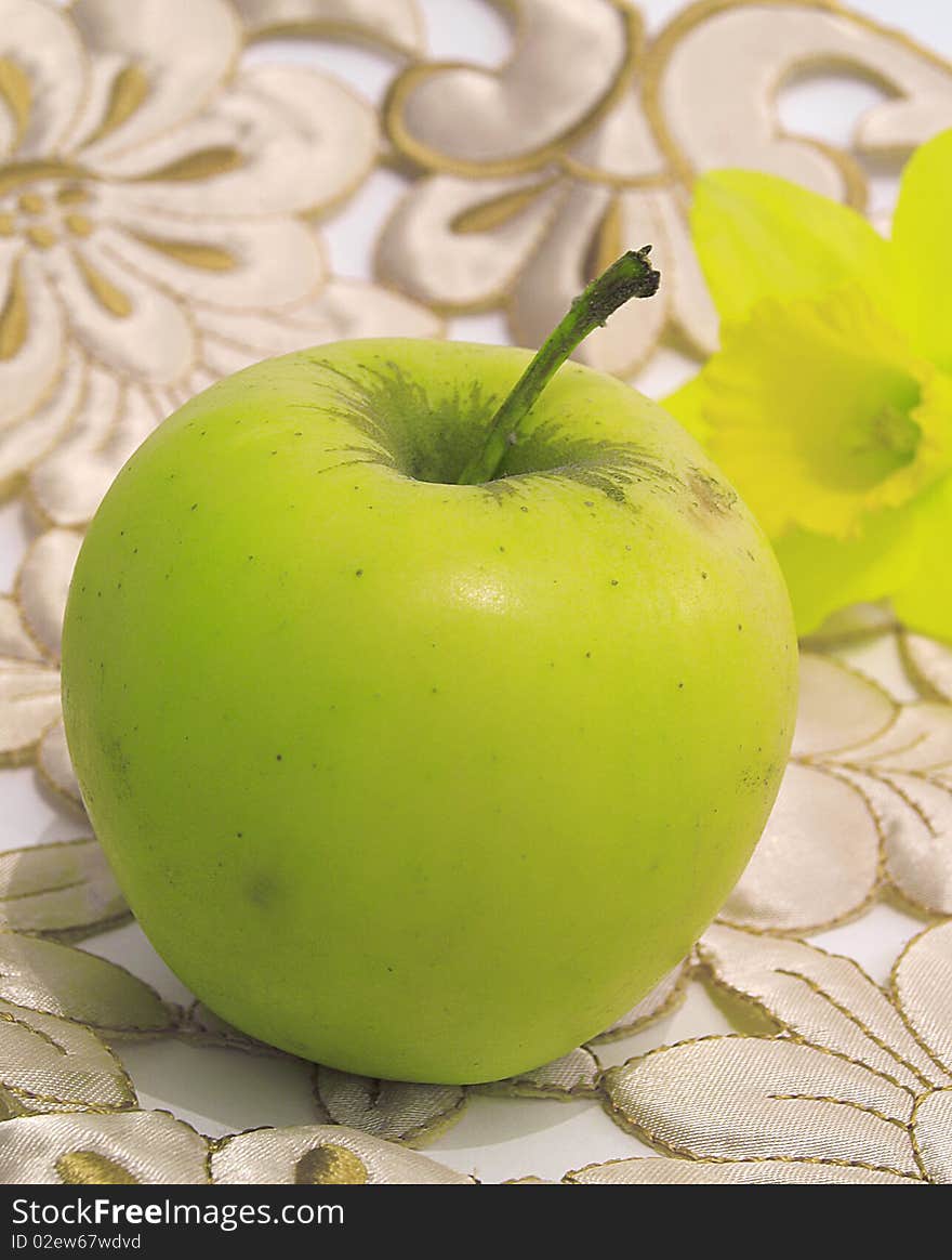 Fresh,green,healthy apple and flower behind,on floral background