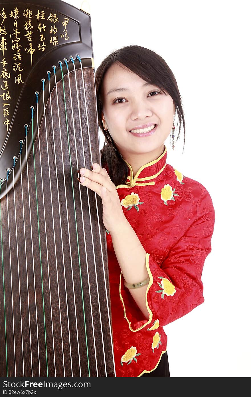 Chinese zither performer in traditional dress with her zither on white.
Chinese character on zither is Chinese Tang poetry,also a famous Tang Dynasty poet's calligraphy. It praised the unique charm of the zither. Chinese zither performer in traditional dress with her zither on white.
Chinese character on zither is Chinese Tang poetry,also a famous Tang Dynasty poet's calligraphy. It praised the unique charm of the zither.