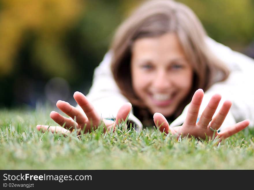 Beautiful young woman relaxing in the grass. Beautiful young woman relaxing in the grass