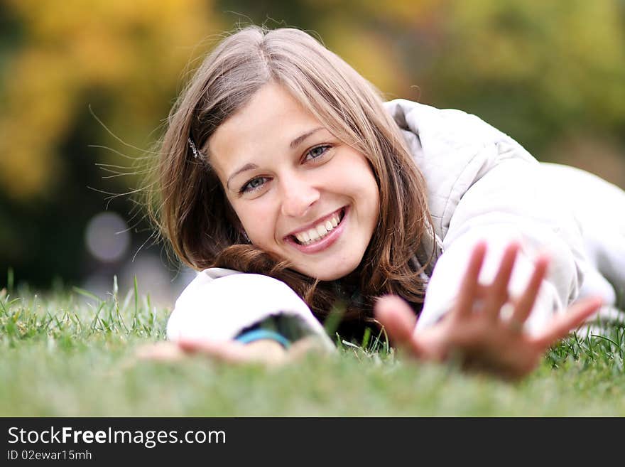 Beautiful young woman relaxing in the grass