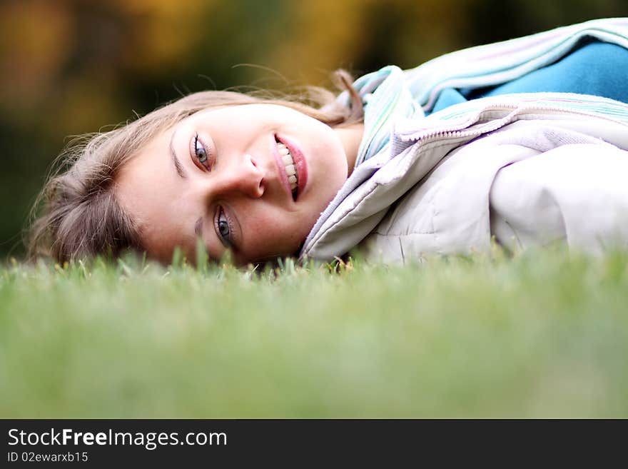 Beautiful young woman relaxing in the grass