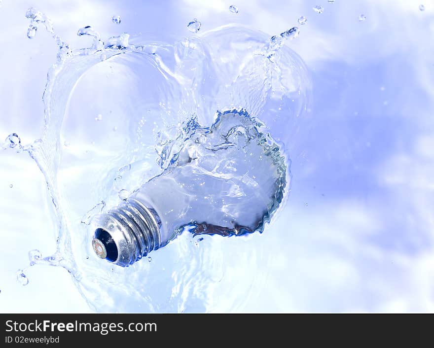 Light bulb in blue water. Technology background