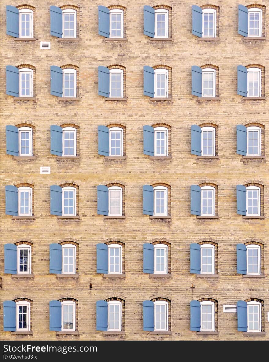 Abstract background image of thirty-six shuttered windows on a vintage building exterior. Abstract background image of thirty-six shuttered windows on a vintage building exterior.