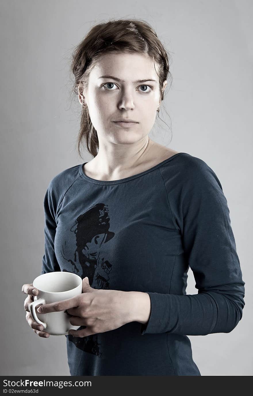 Portrait of young woman holding a cup