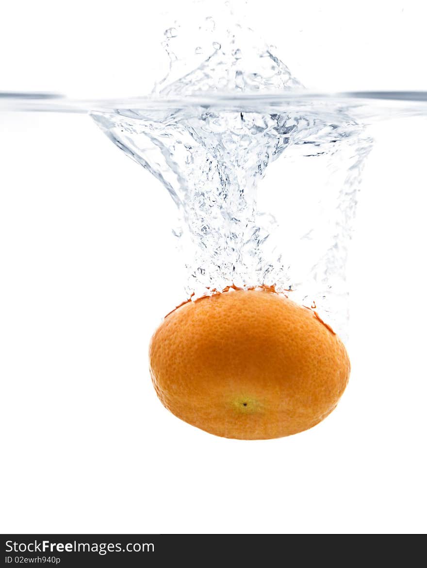 Fresh Tangerine splashing into water with white background