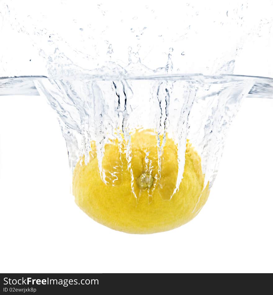 Fresh large lemon splashing into water with white background