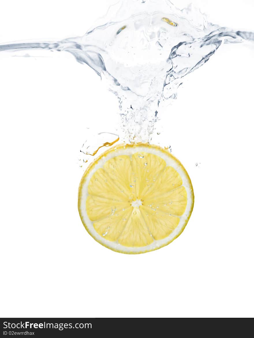 Lemon slice splashing into water with white background