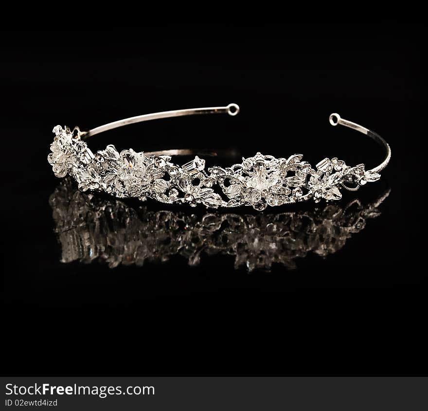 Diamond diadem on a black background with reflexion