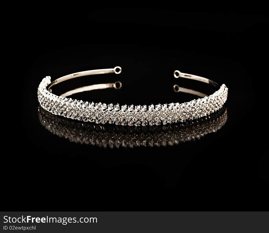 Diamond diadem on a black background with reflexion