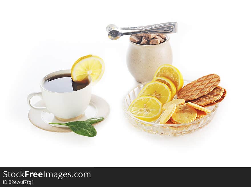 Cup of tea with lemon, pastry  and sugar