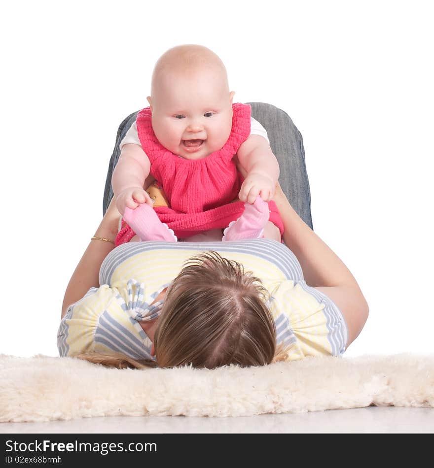 Happy young mother playing with her baby. Isolated on a white background