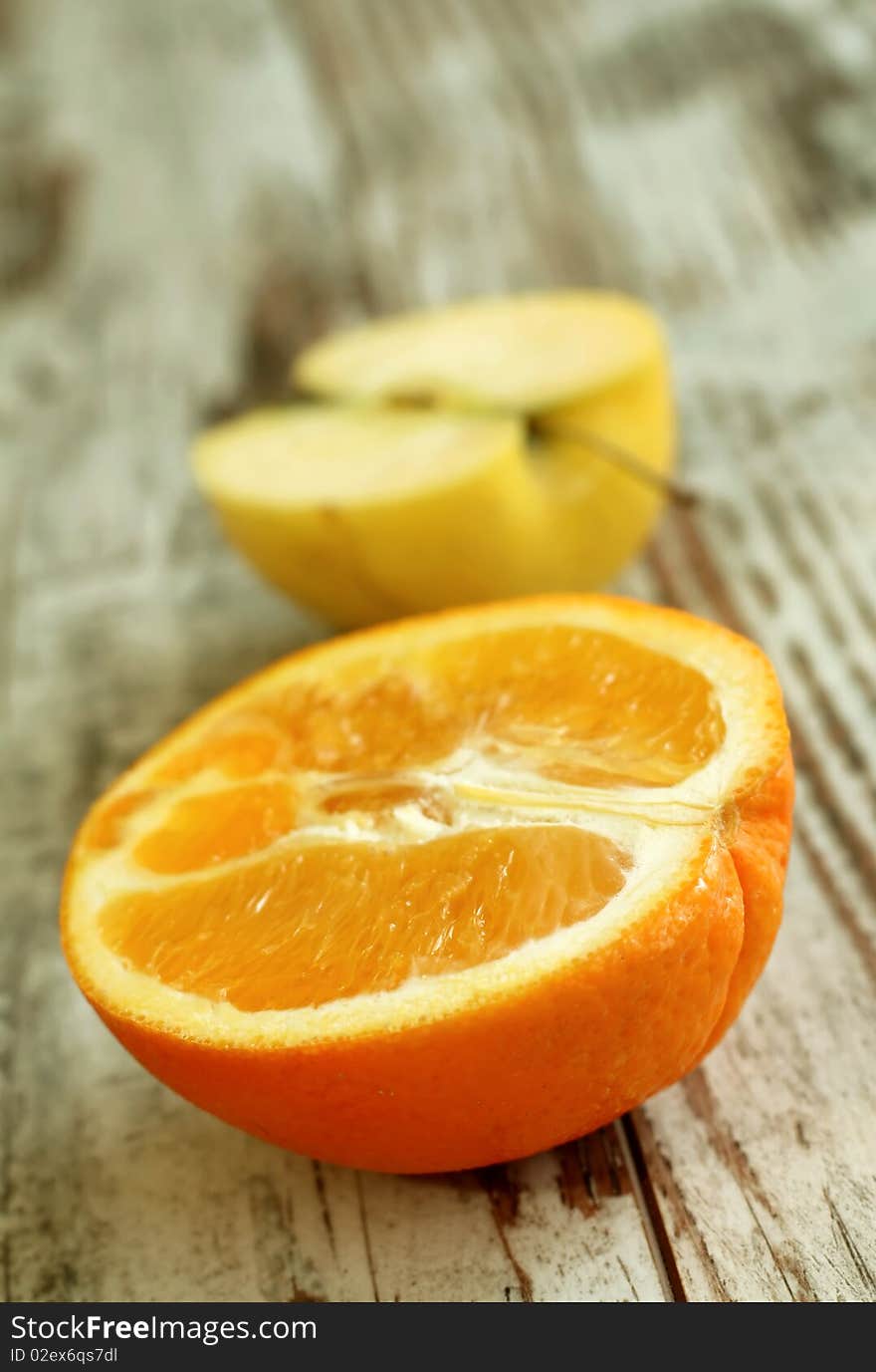 part of orange and apple on wooden background