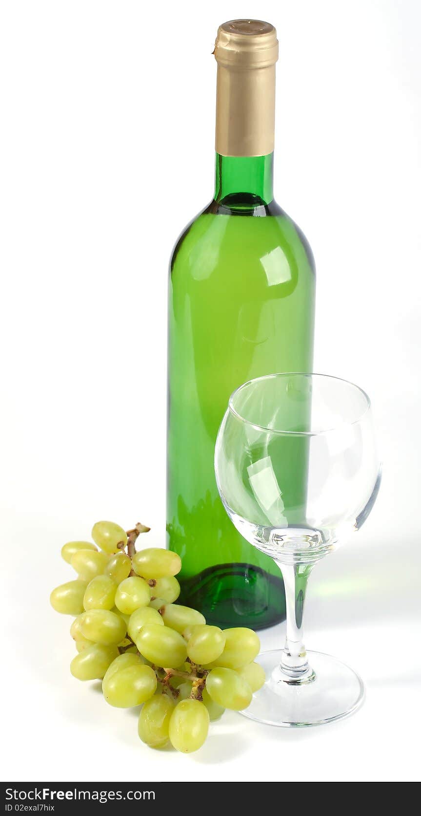 Glass, bottle and grapes on white background