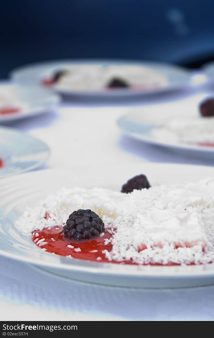 Delicious display of dewberry desert with ice-cream and coconut flakes. Delicious display of dewberry desert with ice-cream and coconut flakes