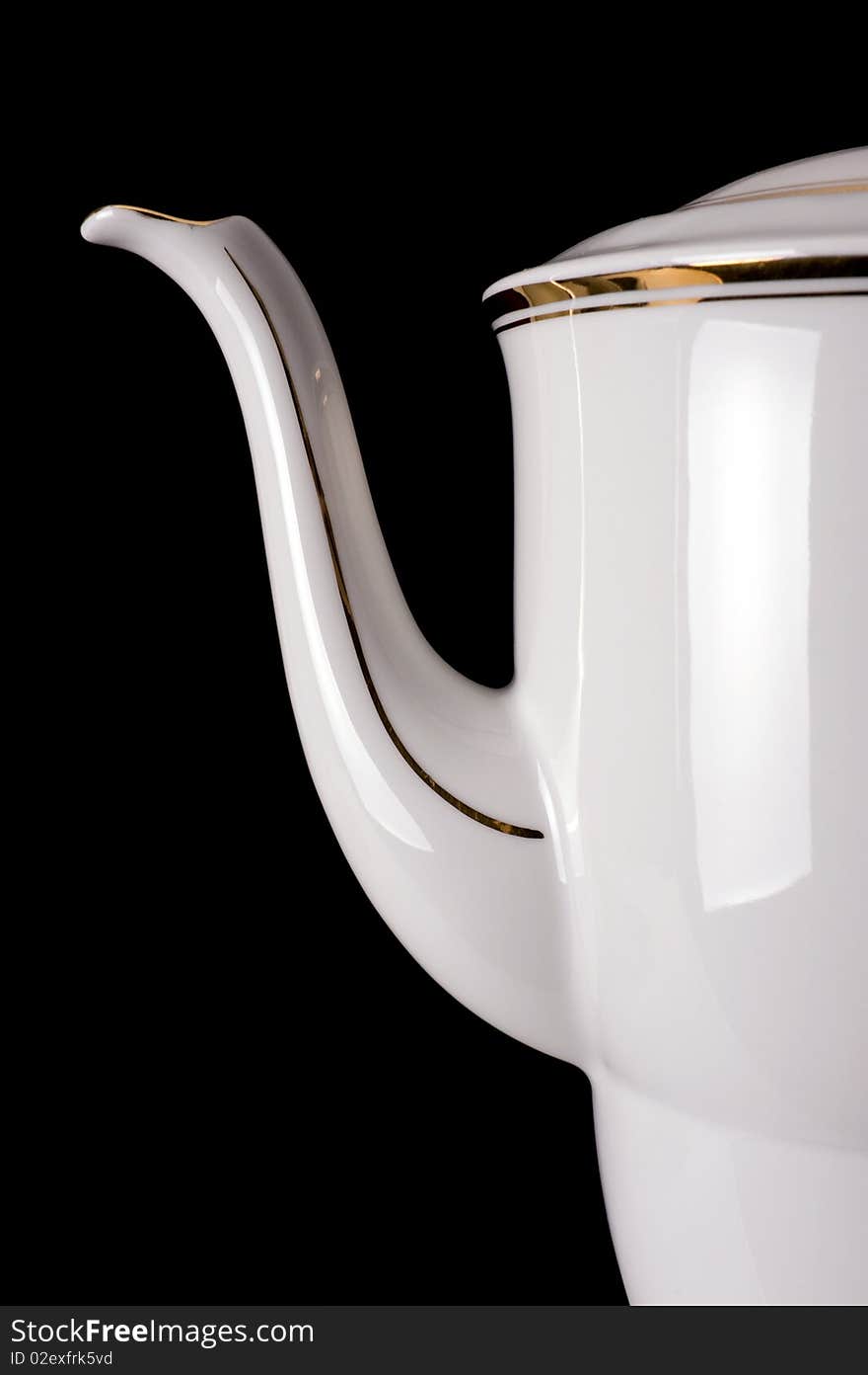 An old porcelain teapot on a black background. An old porcelain teapot on a black background