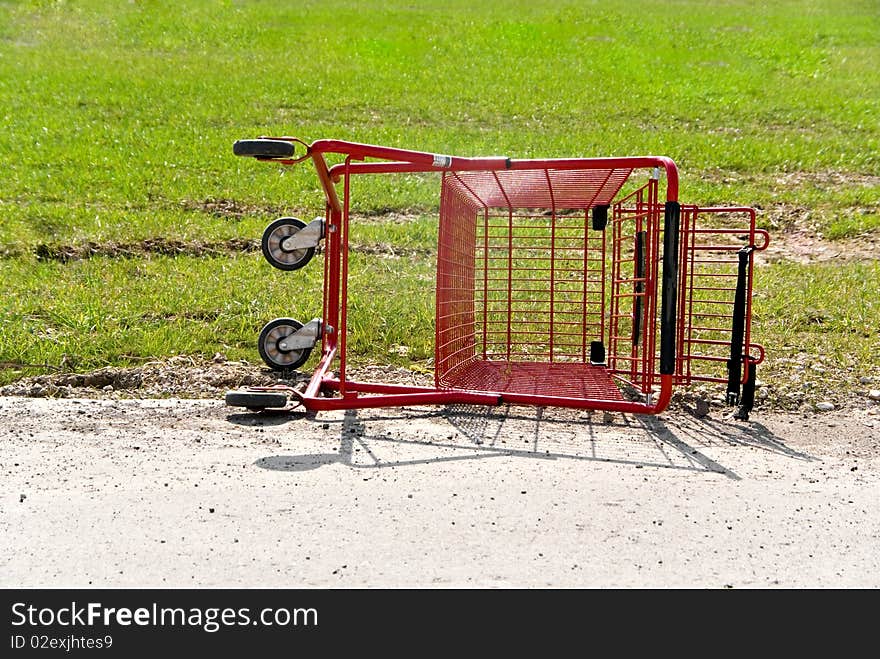 An overturned and abandoned grocery cart. An overturned and abandoned grocery cart.