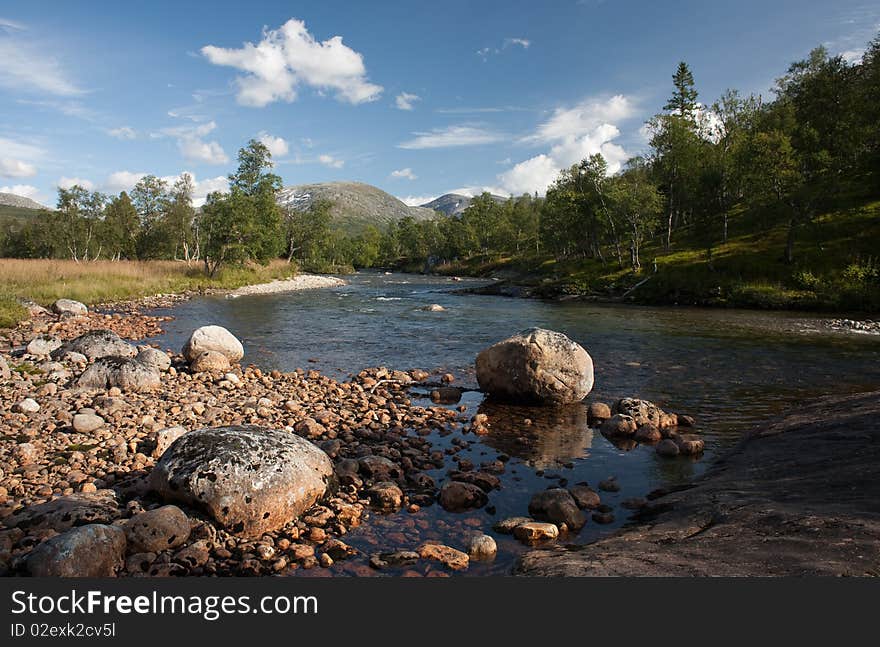 River and mountain on the blue sky background. River and mountain on the blue sky background