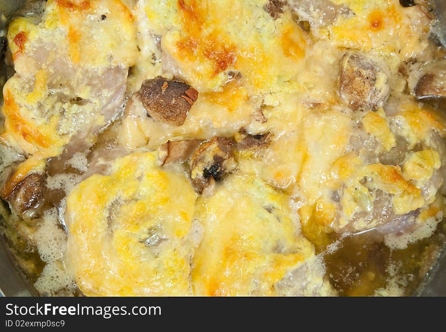 Closeup of  stewed chicken with mushrooms and cheese