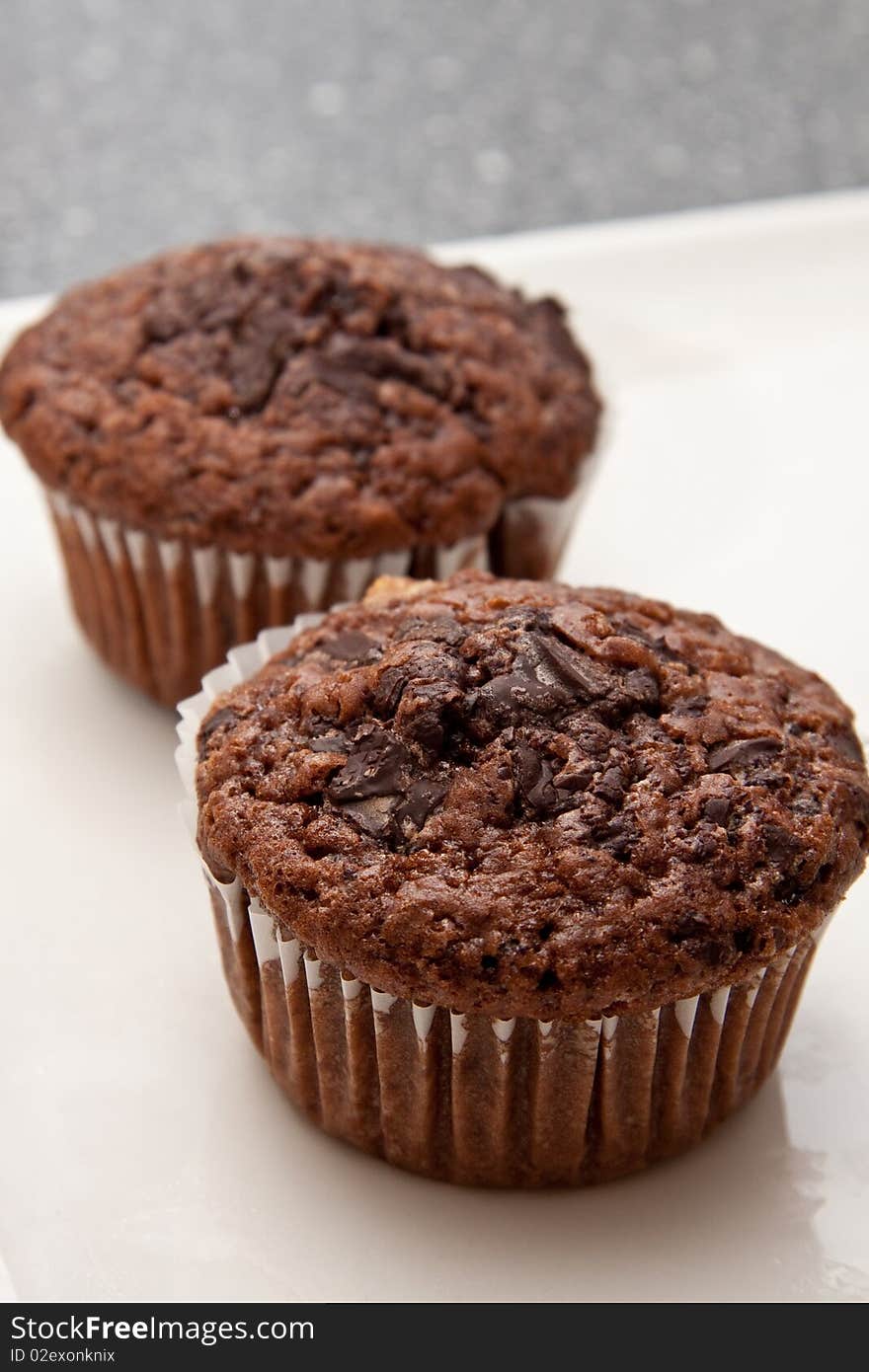 Delicious fresh chocolate muffins standing on a table