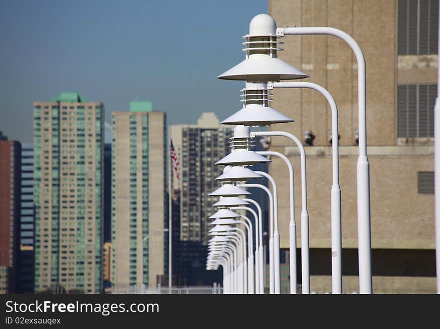 Light poles over modern city skyline. Light poles over modern city skyline