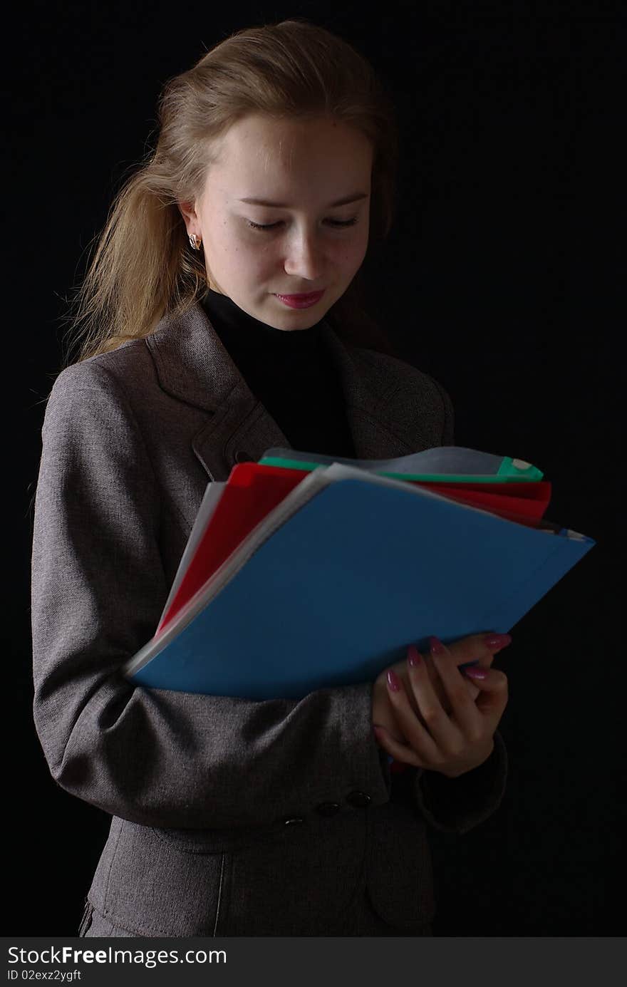 Reading business woman folders on black background