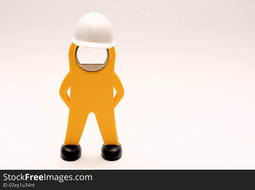 Close-up picture of a figure of a worker with white helmet. Close-up picture of a figure of a worker with white helmet