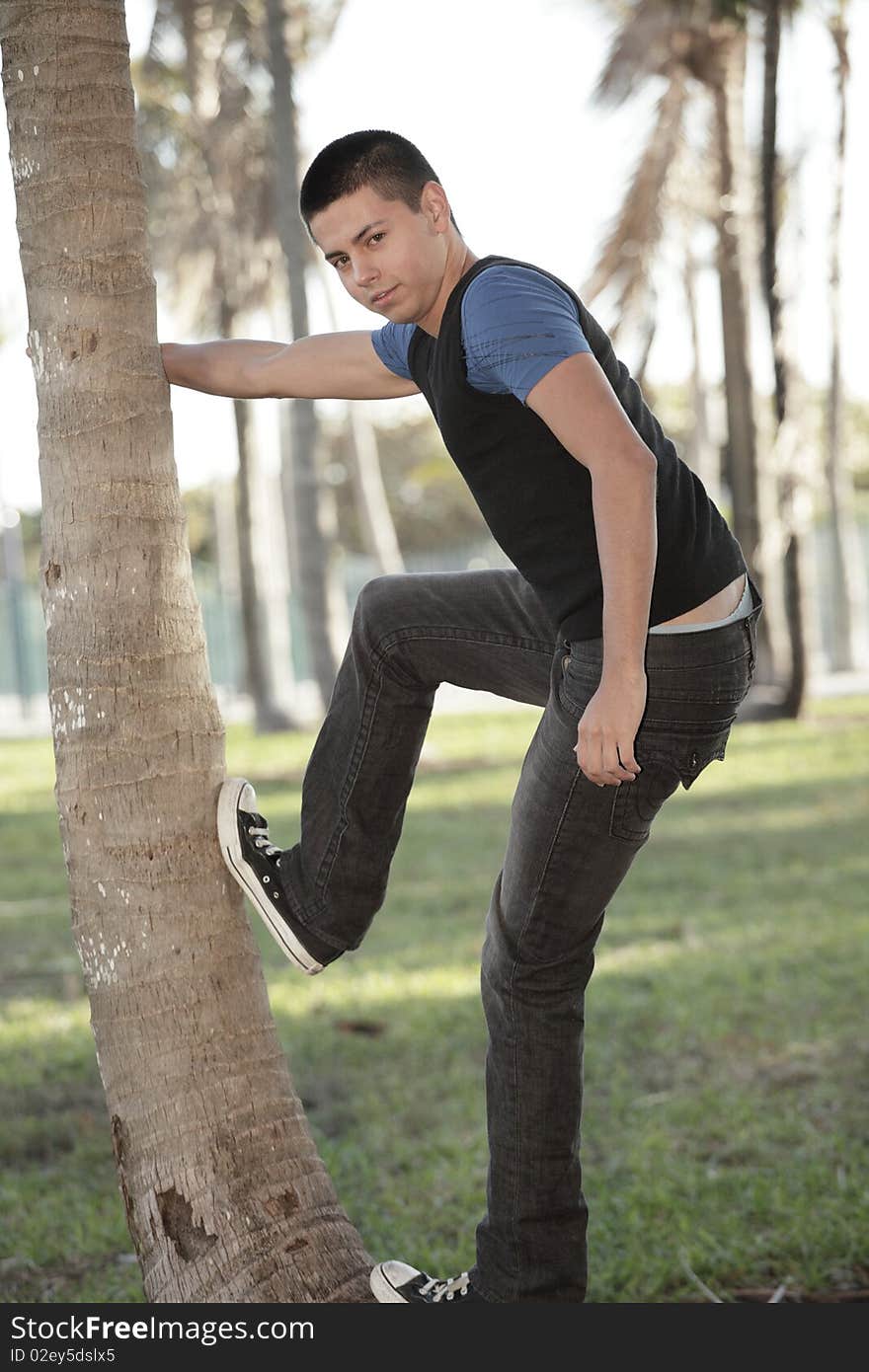 Man posing by a tree