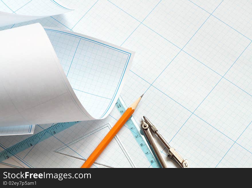 Divider, pencil and ruler on blue graph paper background. Divider, pencil and ruler on blue graph paper background