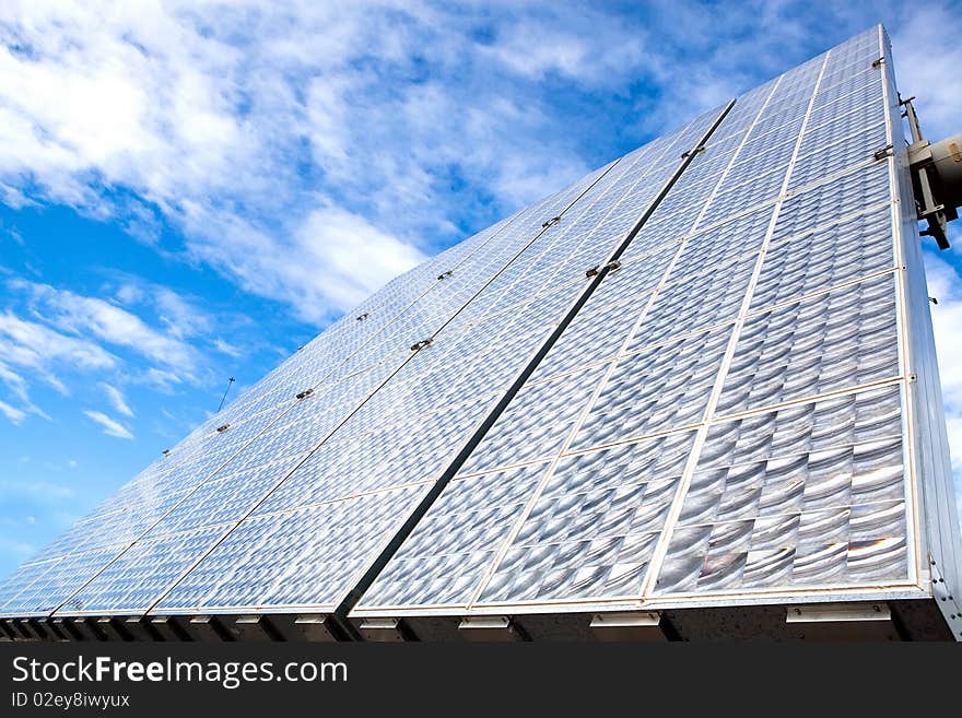 Solar battery panels and blue sky on background