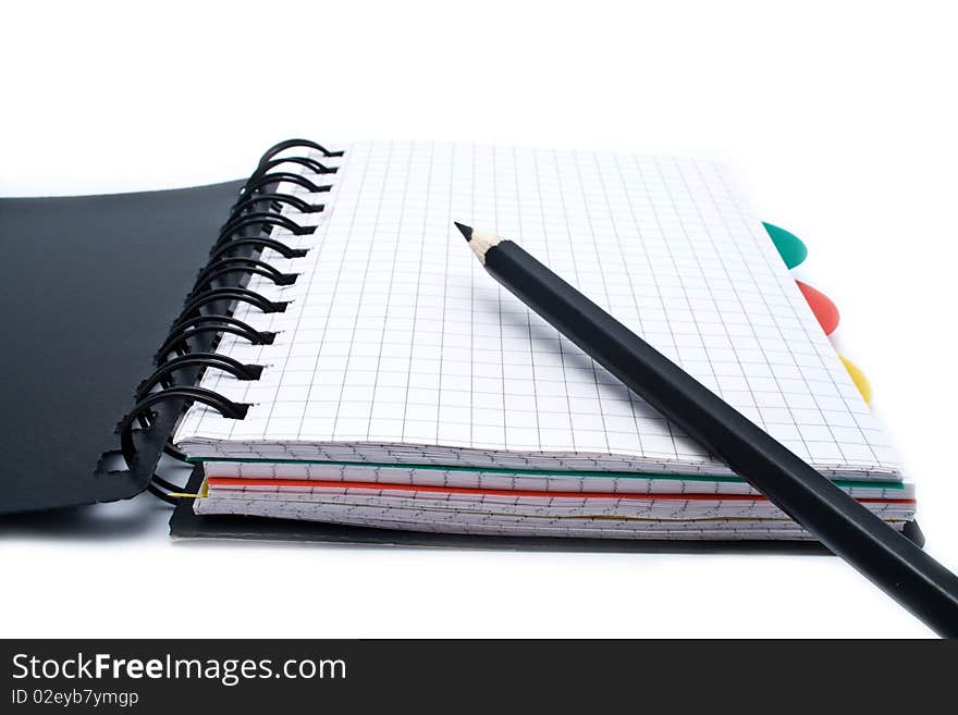 Notebook with a spring and pencil on a white background