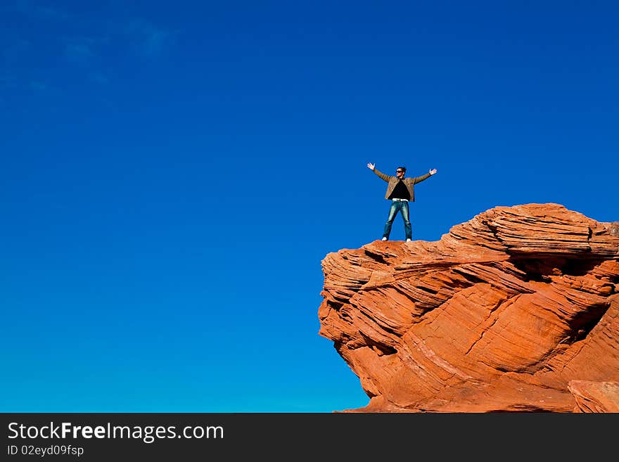 Man standing on the edge of the rock. Man standing on the edge of the rock