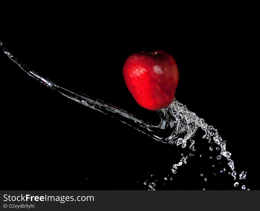 Apple in water on black background